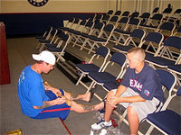 Image: Josh Hamilton, of the Texas Rangers baseball organization, signs a bat for Kolton Smith while the two were visiting during Kolton’s treatment for leukemia.