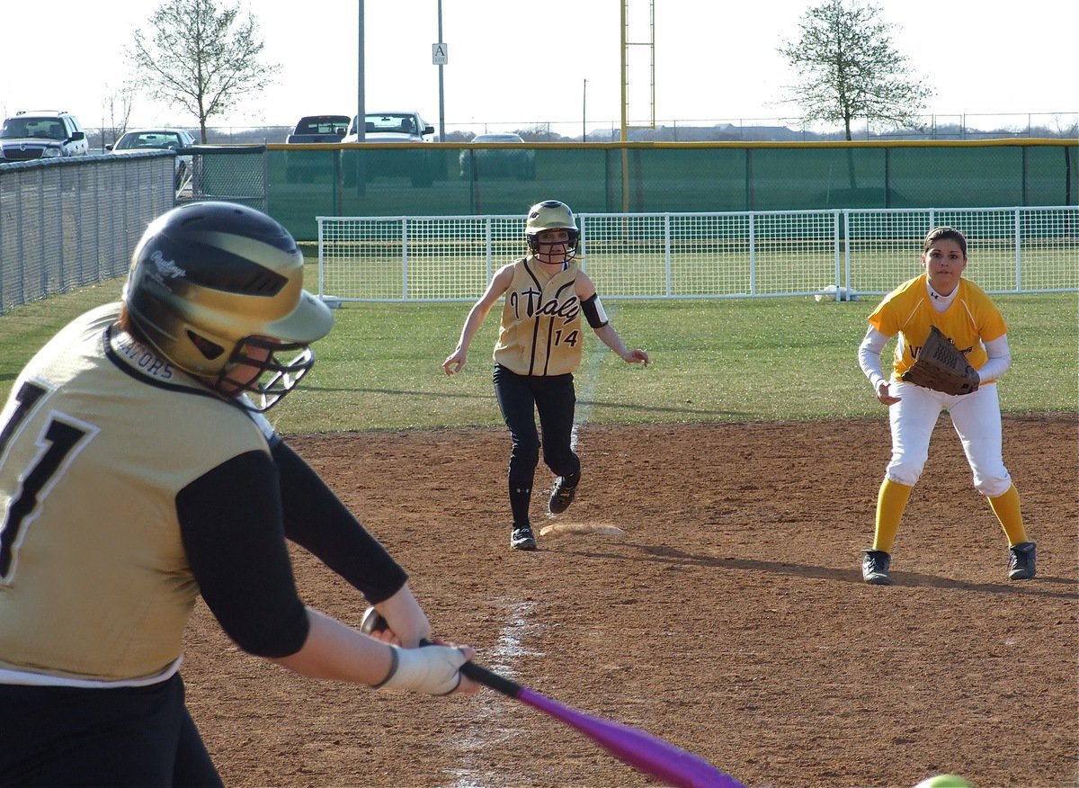 Image: Hit and run — Meredith Brummett(11) knocks in Drew Windham(14) after getting a hit against Arlington Lamar.