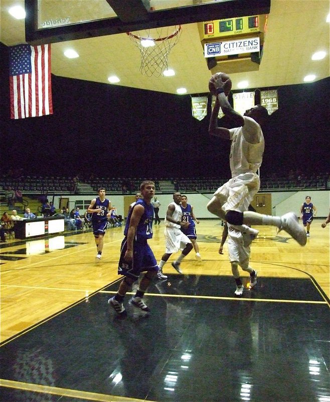 Image: Isaac-oop — Jasenio Anderson(11) tosses an alley-oop pass to John Isaac for 2-points.