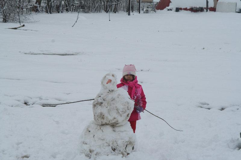 Image: Evie’s creation — Evie South and her brothers and sister work on Carrot Nose Snowman.