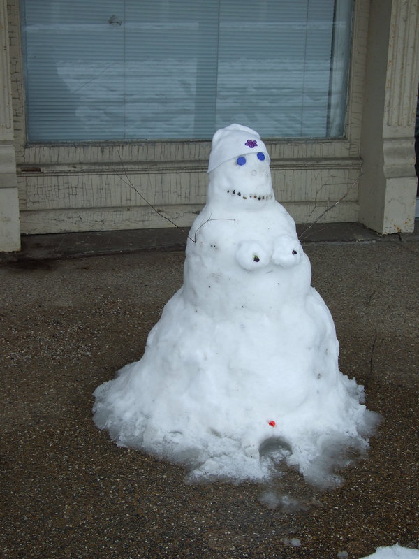 Image: SnowWoman — She was found melting in front of the Uptown Cafe.  Do you think she looks like Sandy?