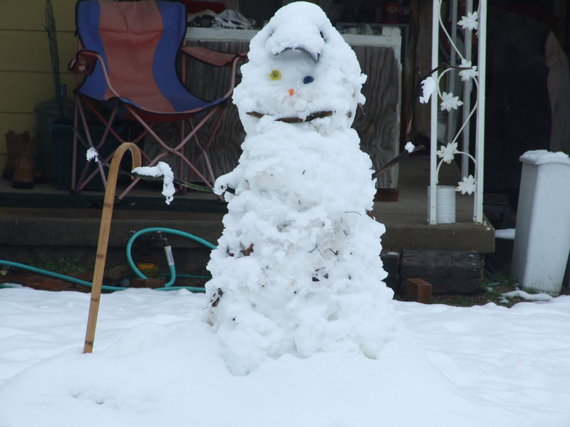Image: Walking Snowman — This snowman is ready to take a walk around the block with his walking stick.