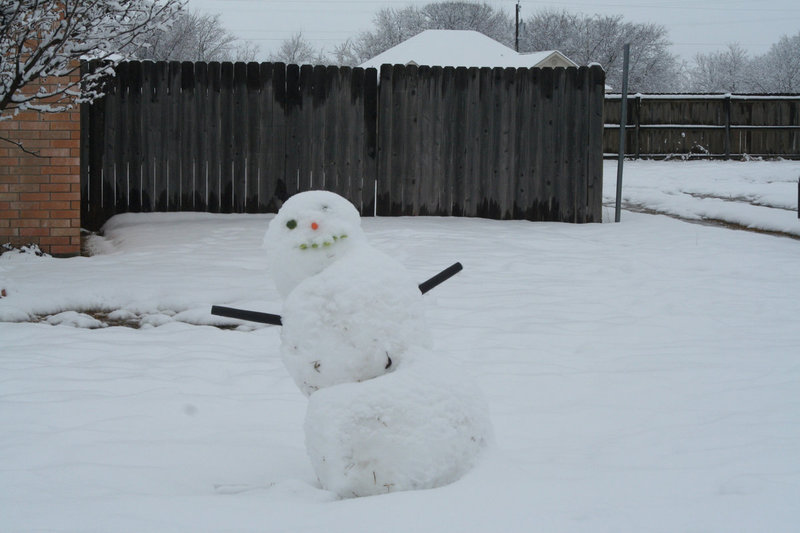 Image: Leaning Tower of Snow-a — If he leans too much more, this snowman will just be taking a nap.