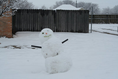 Image: Leaning Tower of Snow-a — If he leans too much more, this snowman will just be taking a nap.
