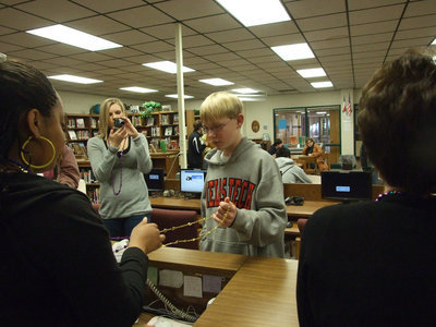 Image: Cody accepts the beads — The library staff is happy to hand out beads for Mardi Gras.
