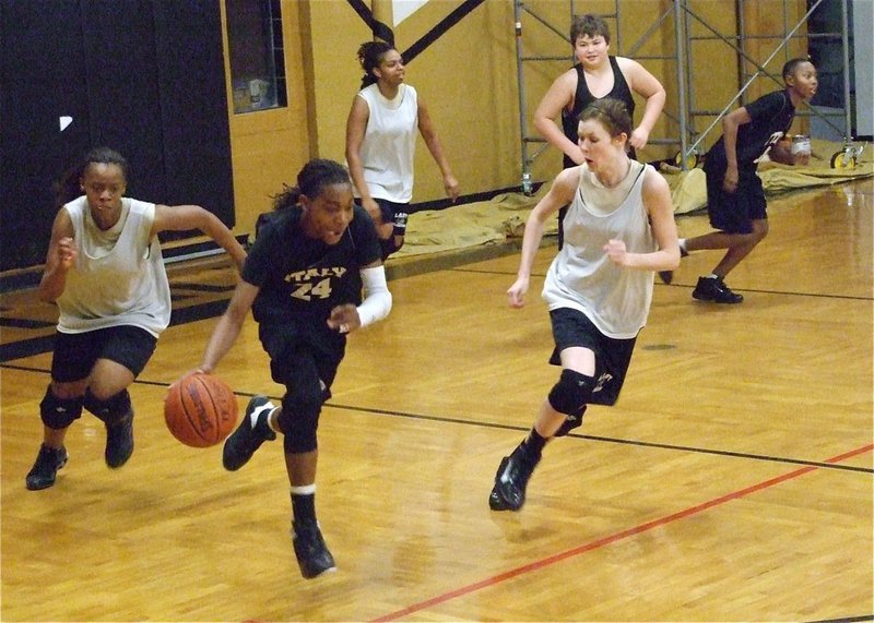 Image: The 8th grade boys scrimmaged the Lady Gladiators on Thursday — Treyvon Robertson(24) takes off while Lady Gladiators Brianna Burkhalter and Kaitlyn Rossa pursue the ball during a fun but intense scrimmage between lads of the Italy Junior High 8th grade boys team and the Varsity ladies.