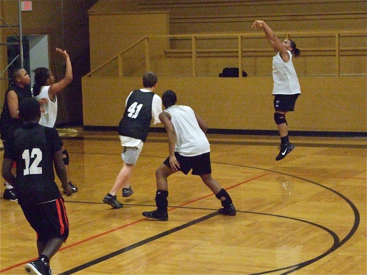 Image: Bombs away — Lady Gladiator Kyonne Birdsong takes an open jumper over the 8th grade boys defense.