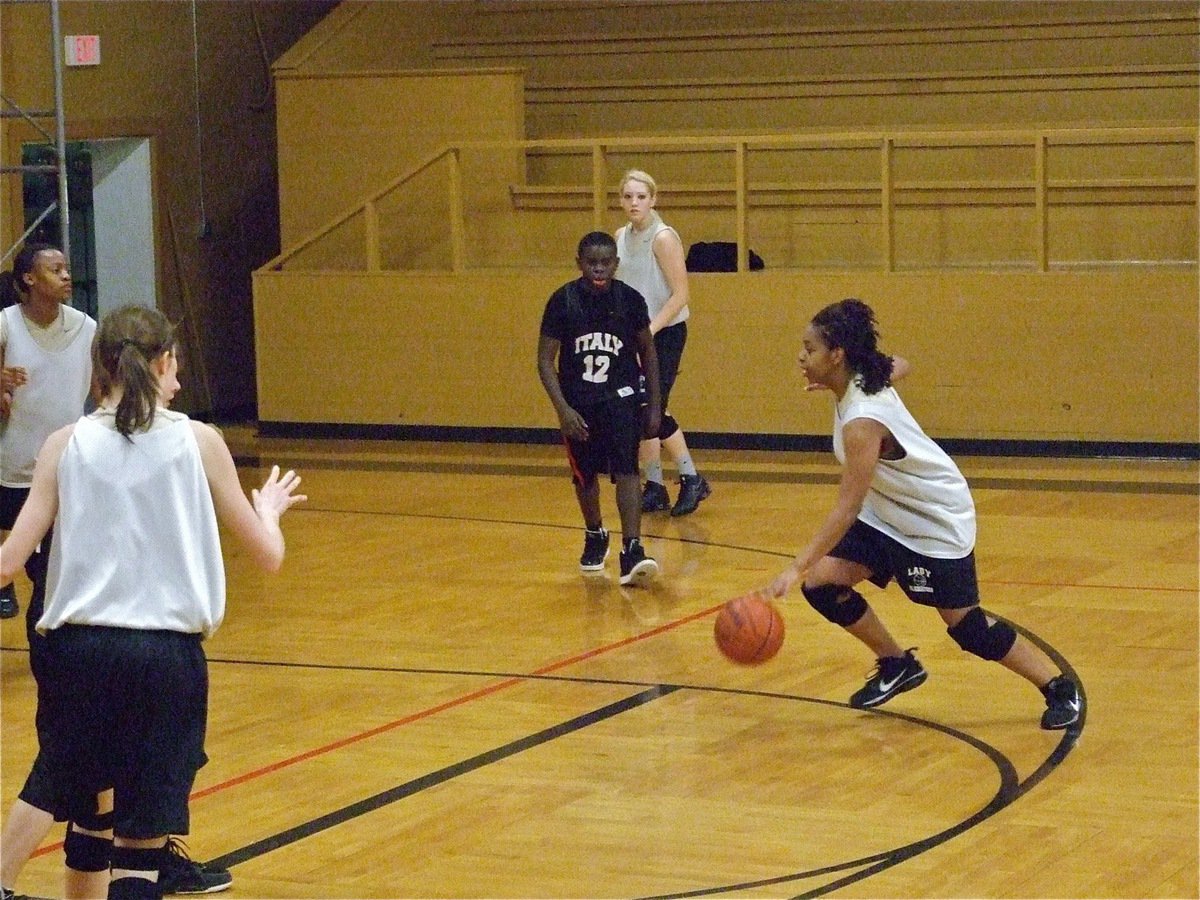 Image: Jaleecia attacks — Jaleecia Fleming attacks a void in the 8th grade boys defense.