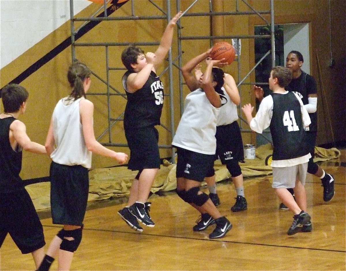 Image: Wisdom vs. youth — The cagey veteran, Jaleecia Fleming, ball fakes Zain Byers and then rises for the score.