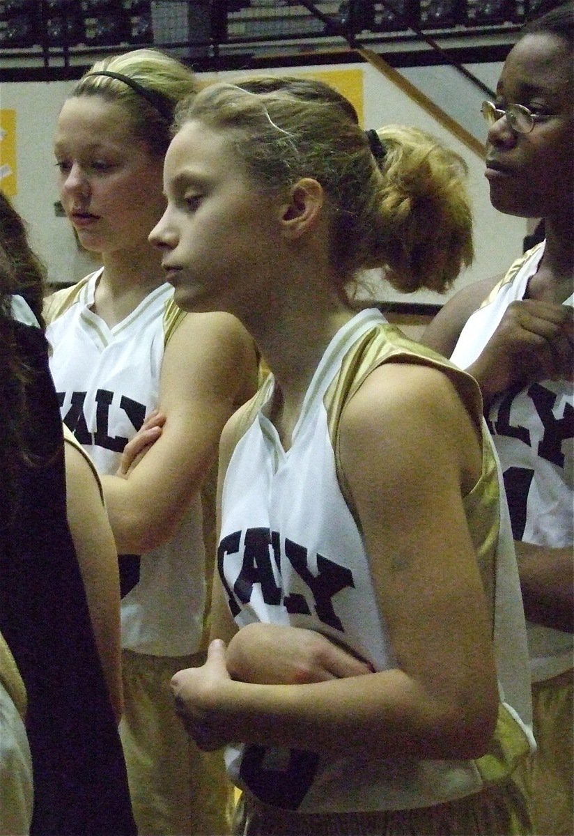 Image: Getting the play — Bailey Eubank, Makenzie Davis-Goodwin and Kierra Wilson intently listen to Coach Richards during a time-out.