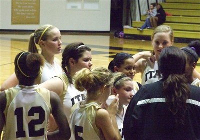 Image: Coaching the team — Coach Tina Richards talks with the 7th grade girls during a timeout.