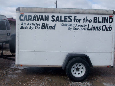 Image: Caravan Sales Trailer — This trailer was filled with lots of brooms and mops and other supplies for sale.