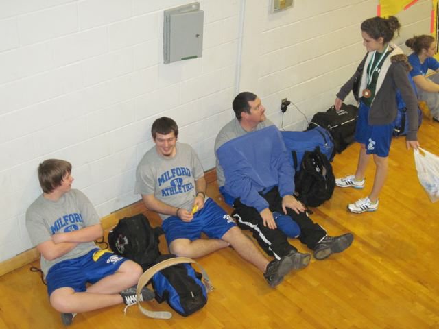 Image: Rachel Strange (far right) — Rachel Strange show Coach Crumpton her fifth place medal.