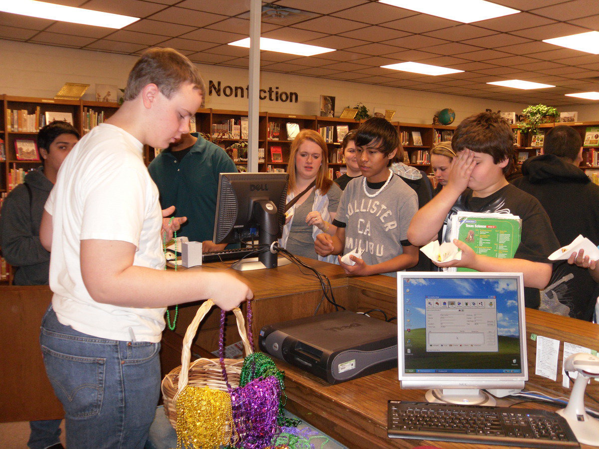 Image: Nolan Griffith passes out beads