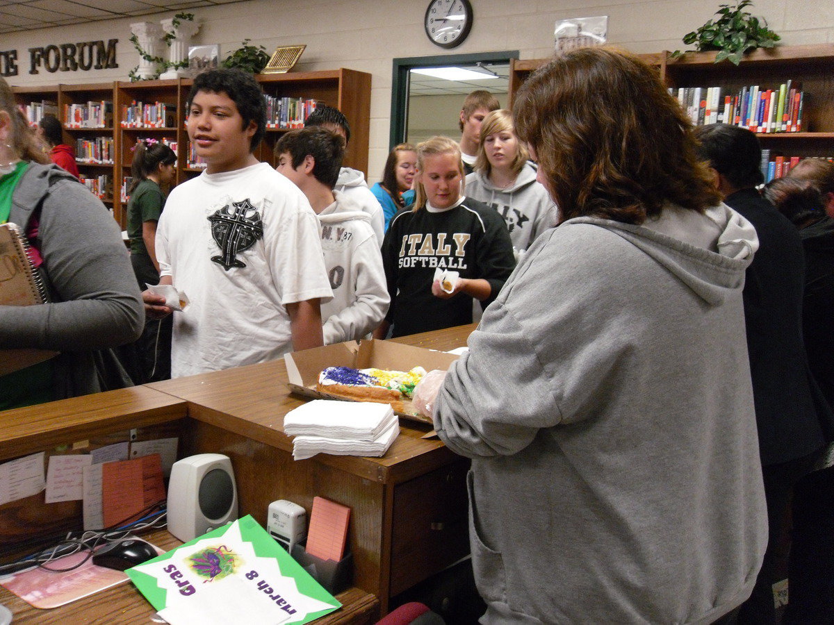 Image: Mrs. Jenni Bales helps serve the Kings cake