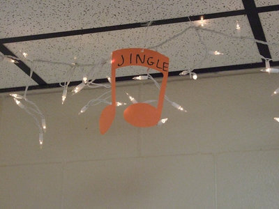 Image: Jingles hang from the ceiling — The class cut out each music note and helped hang them.