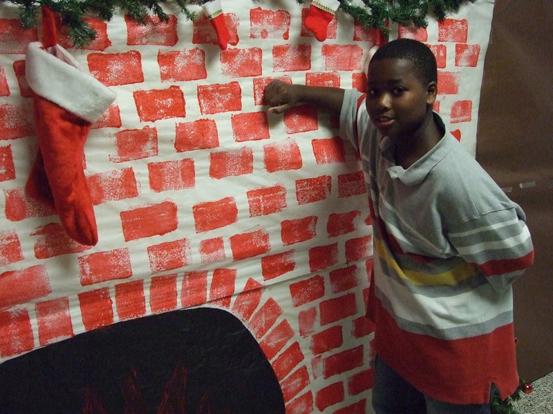 Image: ’Twas the Night Before Christmas — 8th grader, Dominic Wilson, takes a moment and enjoys the decorated hallway his class was in charge of.