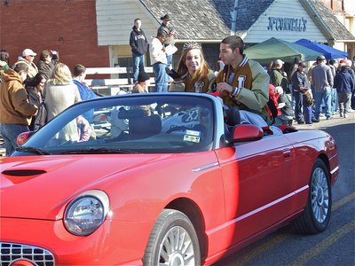 Image: King and Queen — Homecoming Queen Drew Windham and Homecoming King Oscar Gonzalez wave at the crowd from a red convertible driven by Ann Hyles.