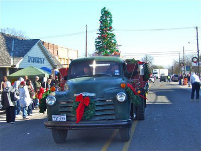 Image: Hobbs Feed &amp; Supply — James Hobbs rolls his old Chevrelet pick-up down Main Street during the Italy Christmas parade.