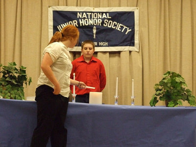 Image: Light the way — Katie Byers lights the candle to induct new officers while Brett Kirton looks on.