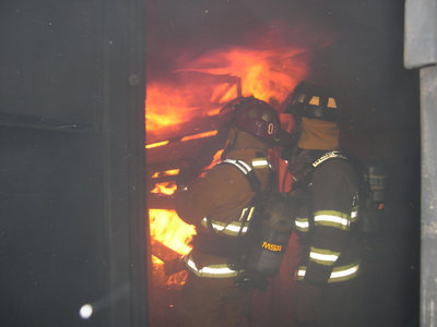 Image: Fire ablaze — The firemen are required to endure the heat of the flames as they try to extinguish the fire in the training house in Waxahachie.