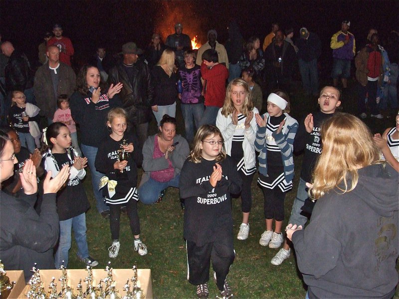 Image: Nice job! — The B-Team Cheerleaders receive their trophies at the IYAA Bonfire Party.