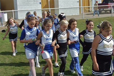 Image: Come join us — In a show of good sportsmanship, B-Team Cheerleaders invite the Rice Cheerleaders over to do a cheer.