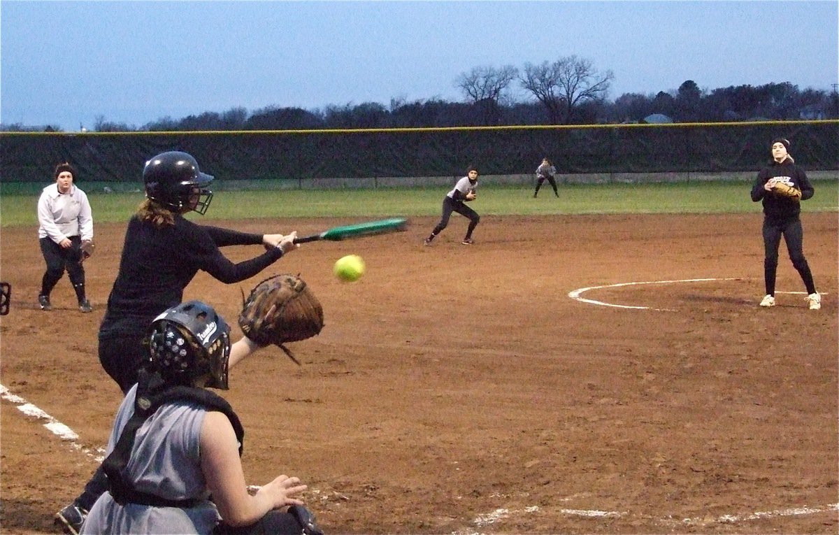 Image: Strike! — Courtney Westbrook delivers a strike into the mitt of catcher Julia McDaniel.