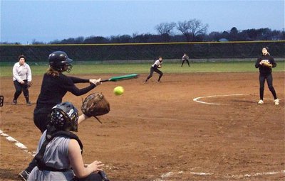 Image: Strike! — Courtney Westbrook delivers a strike into the mitt of catcher Julia McDaniel.