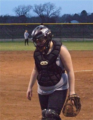 Image: Braving the cold — Catcher Julia McDaniel keeps her sleeves rolled up on a bitterly cold night of softball.