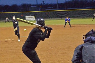 Image: Heater on a cold night — Pitcher Courtney Westbrook finds the corner of he plate for a strike.