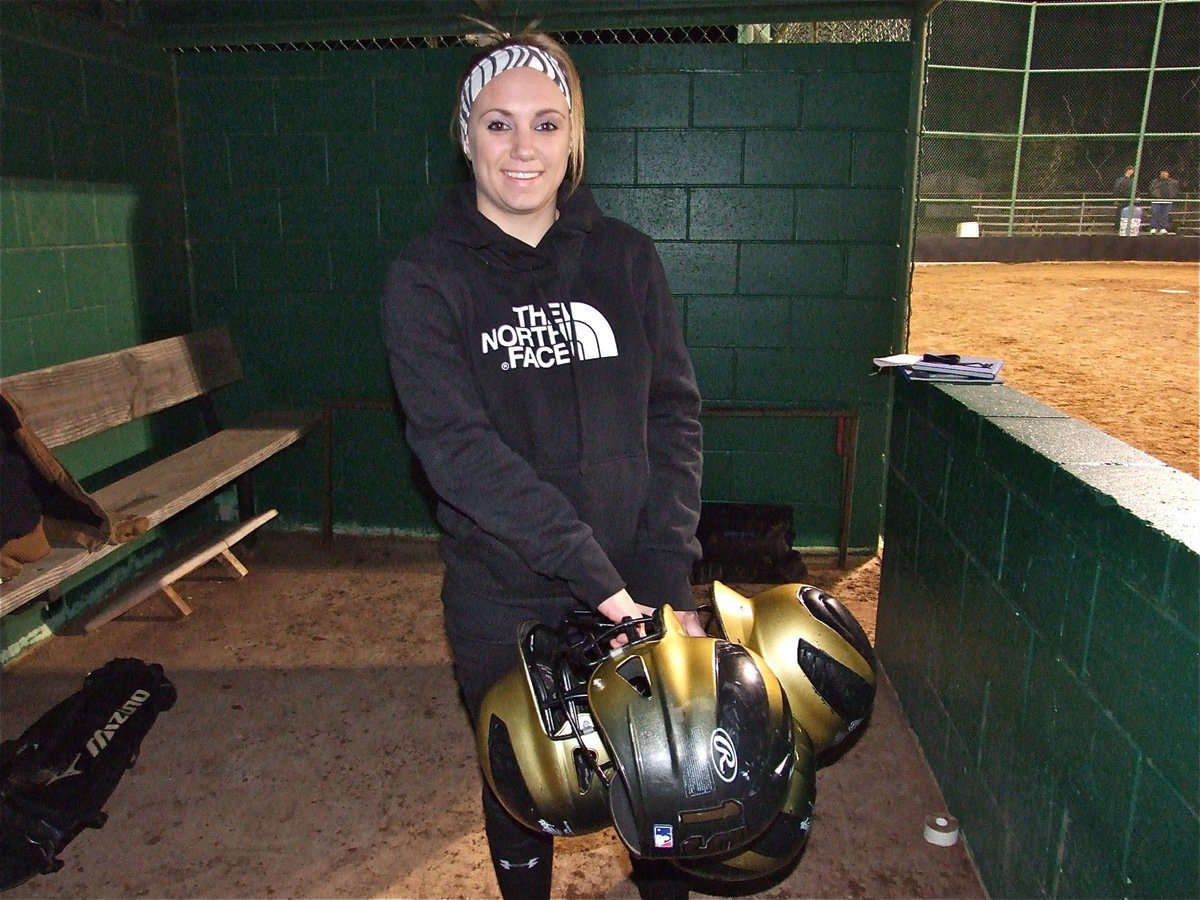 Image: Mary Tate pitches in — Mary Tate helps clear out the dugout after the scrimmage.