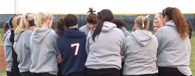 Image: Lady Gladiators huddle — The Lady Gladiators softball team tries to get warmed up for the scrimmage by getting fired up!