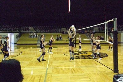 Image: DeMoss sets up — Becca DeMoss sets up to Cori Jeffords for a point.