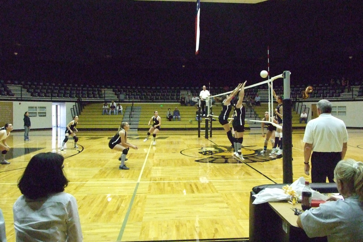 Image: The frontline covers — Blanca Figueroa and Cori Jeffords jump high to block the Lady Eagles.