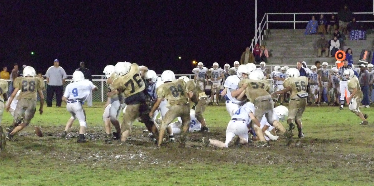 Image: Ball is loose — Wortham loses the handle on the ball and Italy’s Cody Medrano(28) recovers it in the mud.