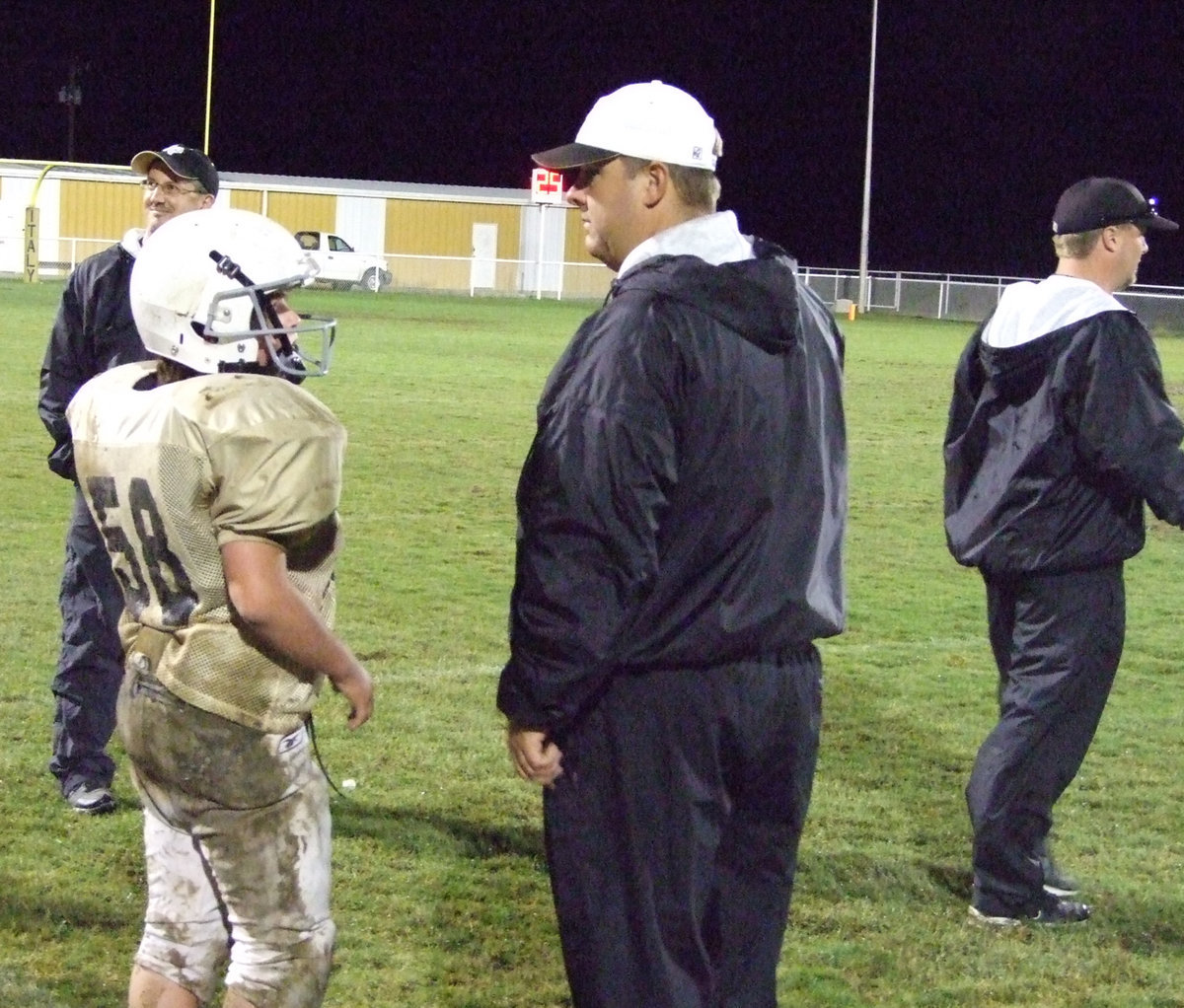 Image: Coaches working hard — Coach Matt Coker, Coach Kyle Holley and Coach Josh Ward coach the Junior High team as Kyle Fortenberry gets set to go in.