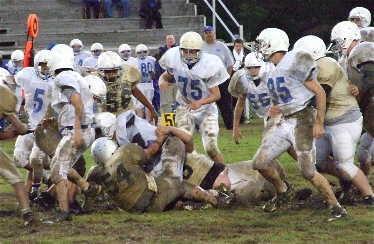 Image: Got ’em! — Sampson and John(54) bring down a Bulldog.