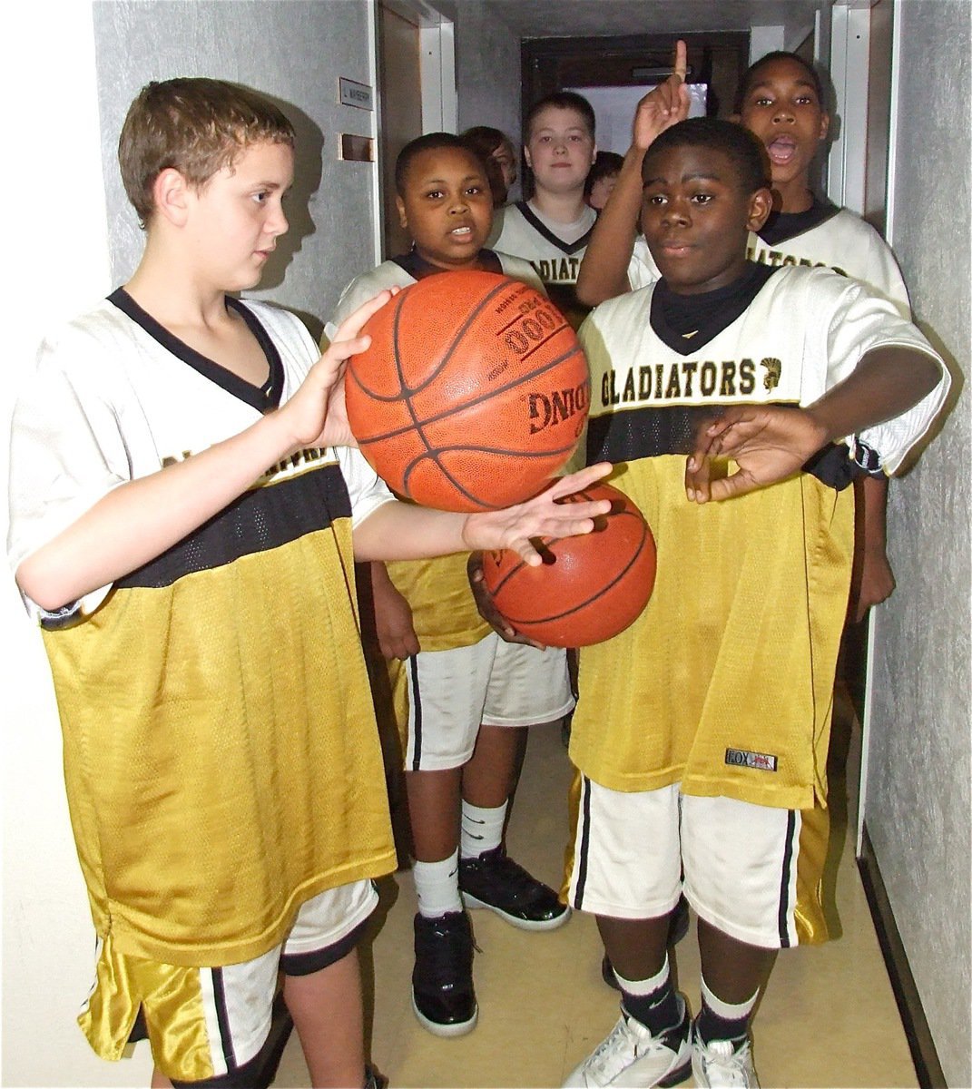 Image: 8th graders get set — Charging out of the tunnel, wearing white trunks with an old gold stripe, are your 8th grade Gladiators. This bout is scheduled for four rounds.