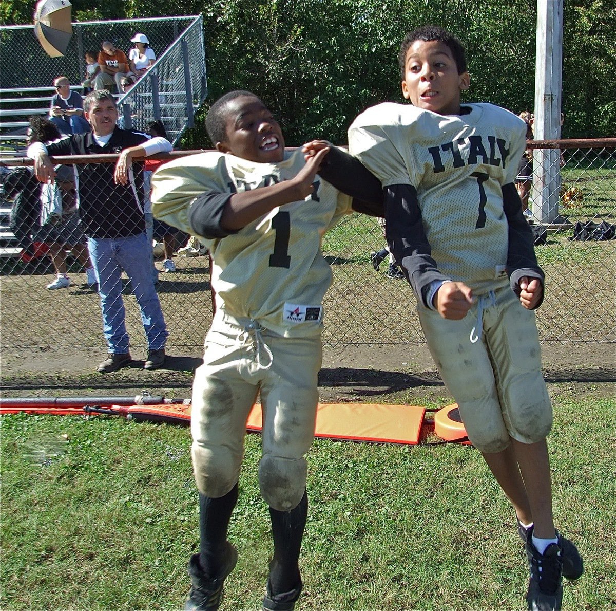 Image: Leaping over Dawson — Kendrick Norwood(1) and Tylan Wallace(7) celebrate their 27-0 shutout win over Dawson as the B-Team leaps to 5-0.