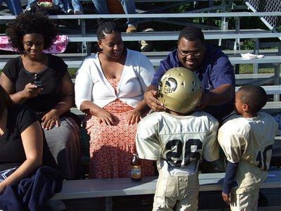 Image: The Jackson 2 — Joe Jackson(26) and his cousin, Darrin Jackson(10), get a little help from their families after the game.