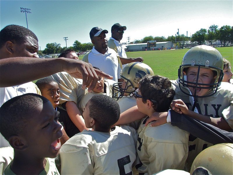 Image: We did it! — The C-Team coaches break for the day after taking care of business against Dawson 27-0.