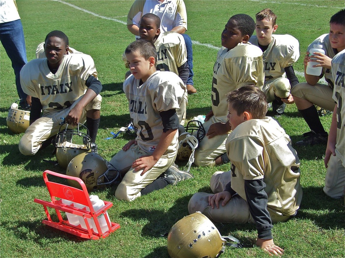 Image: Basking in the glory — A-Team enjoys a relaxing talk with their coaches after shutting out the Dawson Bulldogs 22-0.