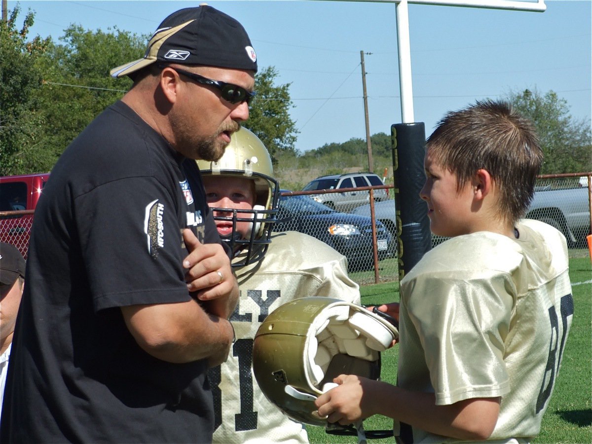 Image: Try it this way — The A-Team gets coached up during halftime.