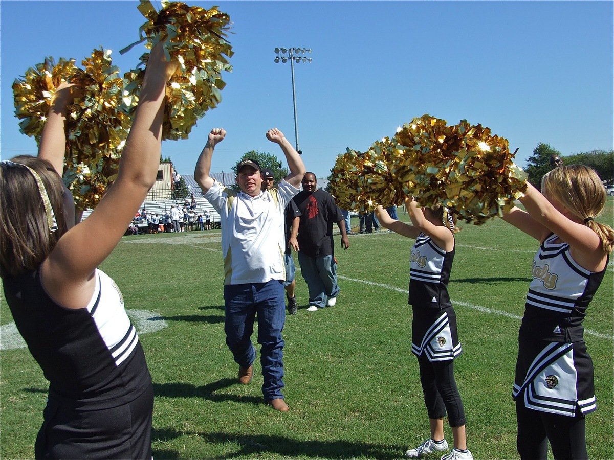 Image: We won! — A-Team assistant coach Scott Connor raises in arms in triumph after the A-team beat the Dawson Bulldogs 22-0 to improve their record to 2-2.