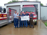 Image: Check presentation — Volunteer firefighters present included Mark Jackson, chief, Andy Frank, safety officer, Milford VFD; Don Chambers, chief; Droll, Italy VFD; and Floyd and Bobby McBride, Forreston VFD. Roger Oliver and John Pearson, operation supervisors, and Kelly Owen, manager of public affairs, for Atmos Energy presented the check.