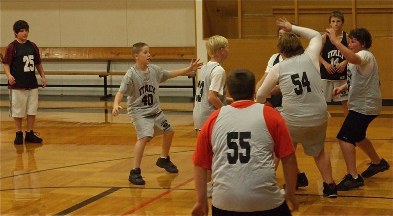 Image: 7th Grade works defense — The IJH 7th grade squad worked on their defense during Tuesday’s practice session. Pictured are: Kyle Fortenberry(25), John Escamilla(40), Cody Boyd(33), Kelton Bales(55), Tyler Vincell(54), John Byers(52), Colton Petry(14) and Chase McGinnis(23) is the player being swarmed.