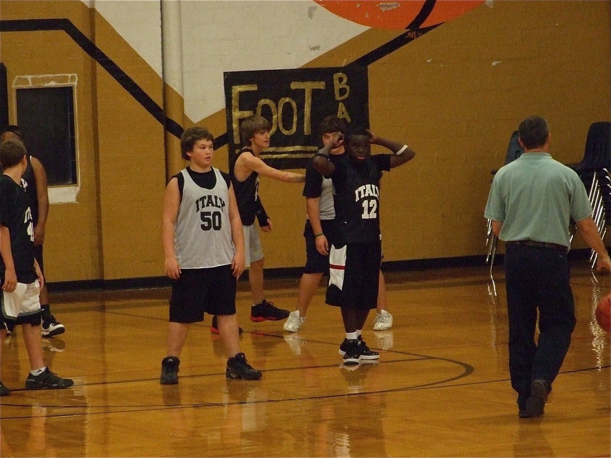 Image: Amazing moves — A former Gladiator hoopster himself, Coach Kyle Holley shows off his old point guard moves against the 8th grade defense during practice.