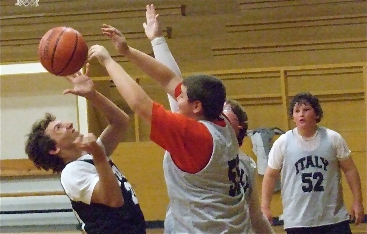 Image: In the paint — Battle under the boards. Kelton Bales(55) and Tyler Vincell challenge Chase McGinnis’s(23) shot attempt as John Byers(52) looks on.