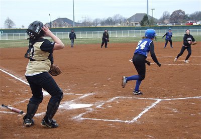 Image: No problem — With a runner on base, catcher Julia McDaniel reacts to a pop-up while teammate Courtney Westbrook hauls it in near the pitcher’s mound.